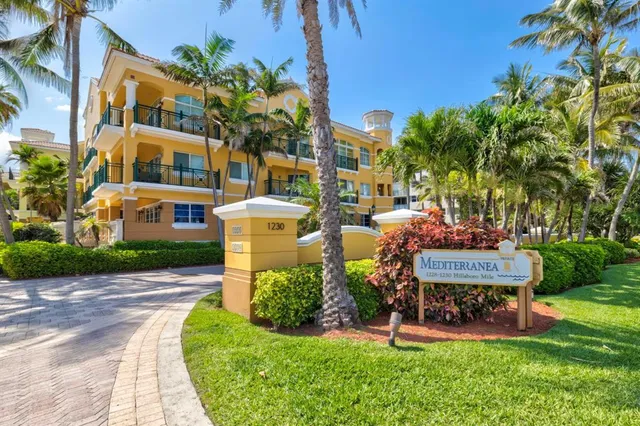 an aerial view of a house with a garden and lake view