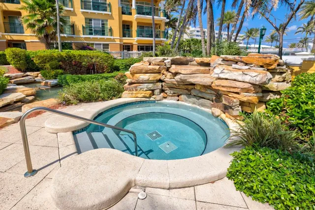 a front view of a house with swimming pool having outdoor seating