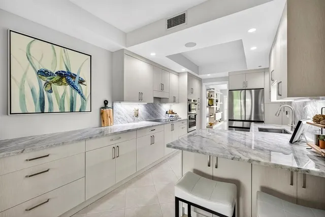 a kitchen with sink and white cabinets