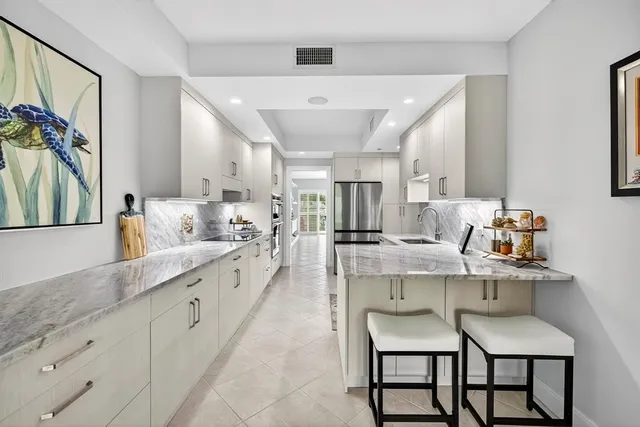 a kitchen with stainless steel appliances kitchen island granite countertop a sink and cabinets