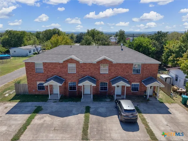 a aerial view of a house with swimming pool and furniture