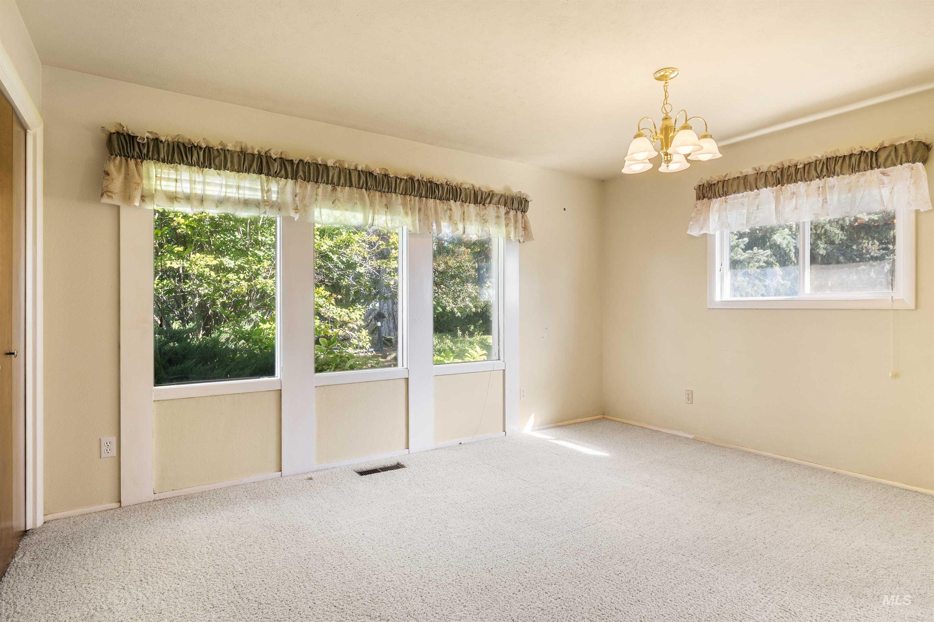 415 West 300 South Heyburn, ID 83336 - Photo 12 of 50 Carpeted spare room with a chandelier and baseboards