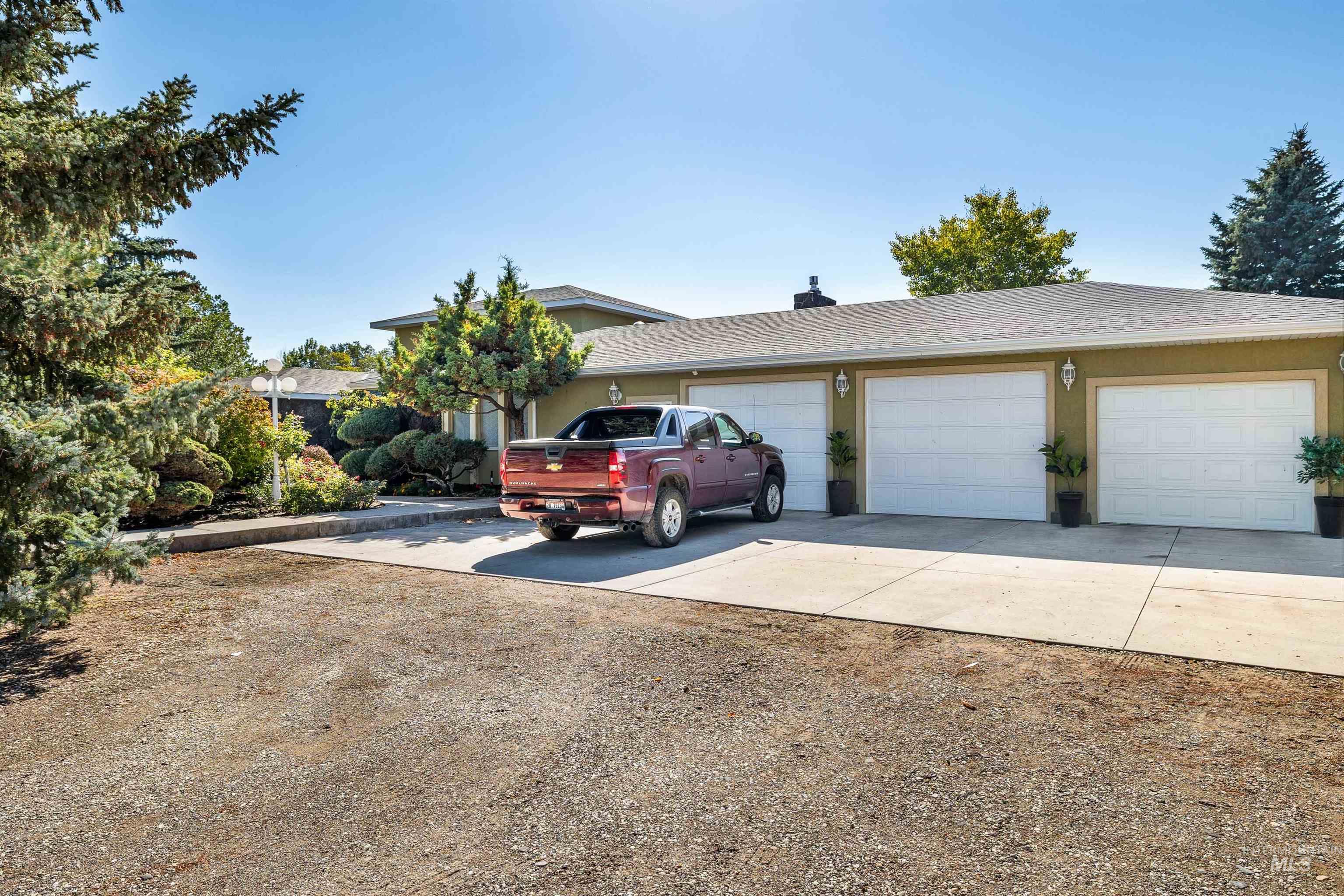 415 West 300 South Heyburn, ID 83336 - Photo 2 of 50 View of front of home featuring concrete driveway, an attached garage, roof with shingles, and stucco siding