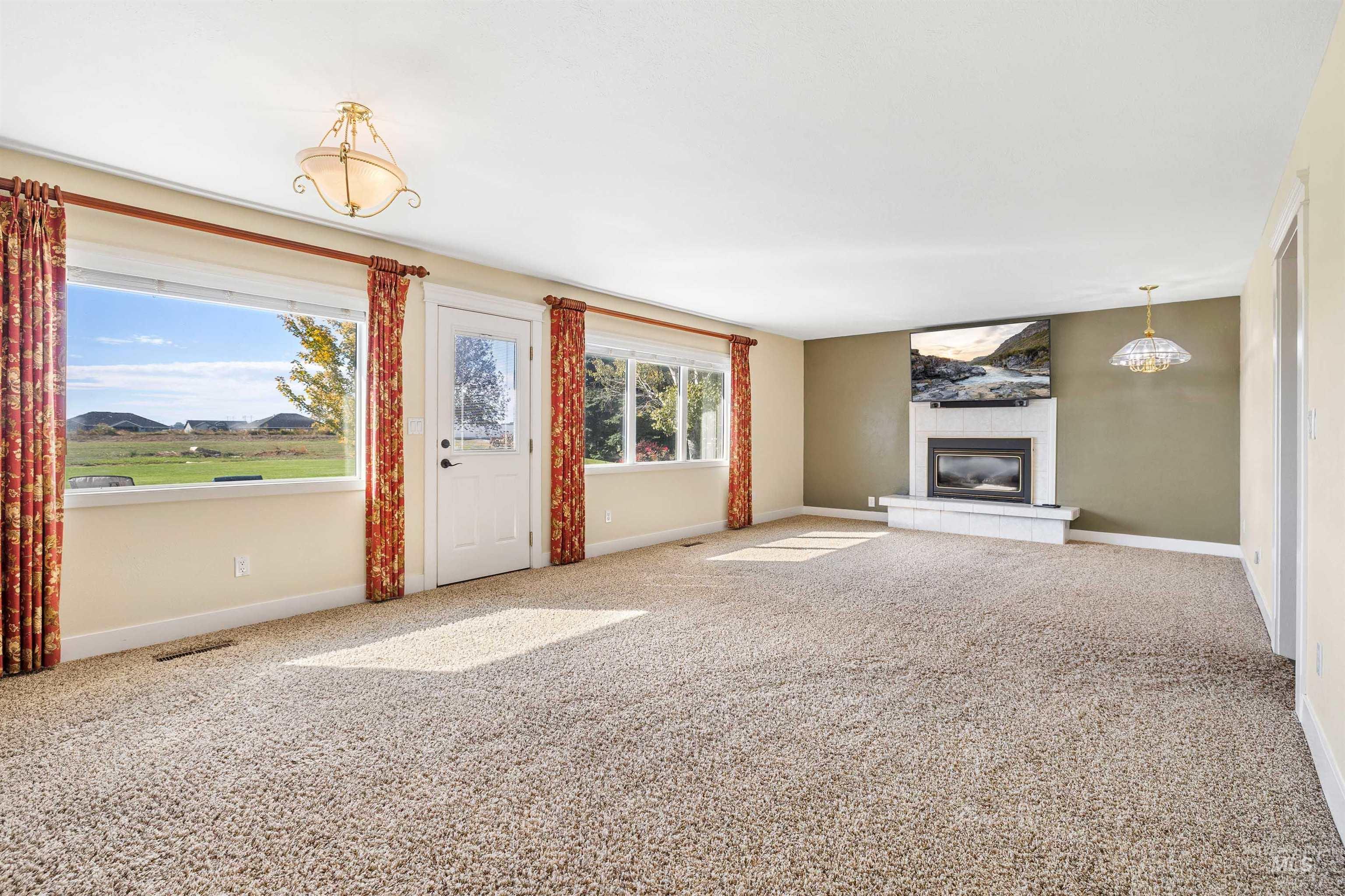 415 West 300 South Heyburn, ID 83336 - Photo 7 of 50 Unfurnished living room with carpet floors and a tiled fireplace