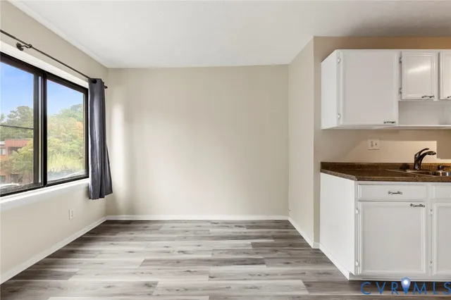 a view of a kitchen with granite countertop cabinets and a wooden floor