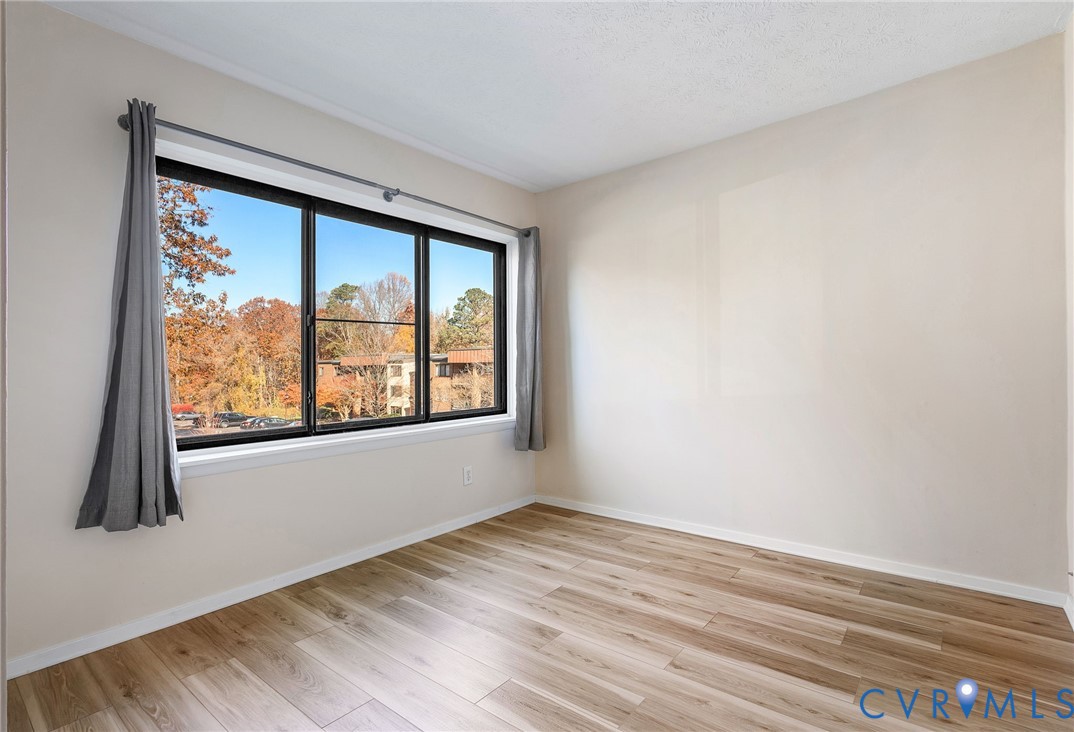1501 Largo Road, Unit 201 Henrico, VA 23238 - Photo 19 of 31 an empty room with wooden floor and windows