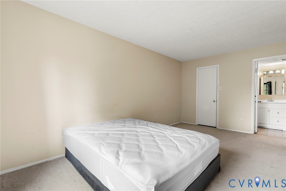 1501 Largo Road, Unit 201 Henrico, VA 23238 - Photo 26 of 31 a bedroom with a bed and a night stand