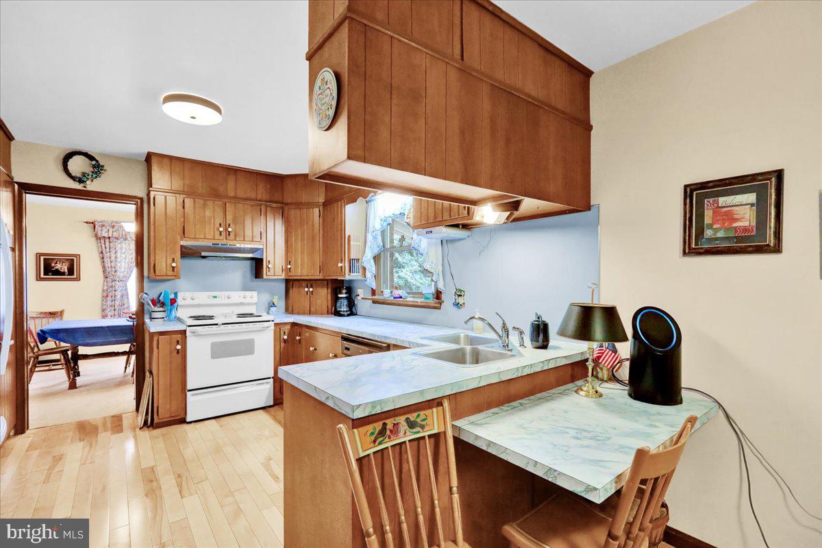 830 North Church Road Reading, PA 19608 - Photo 21 of 57 a kitchen with a stove a refrigerator and wooden cabinets