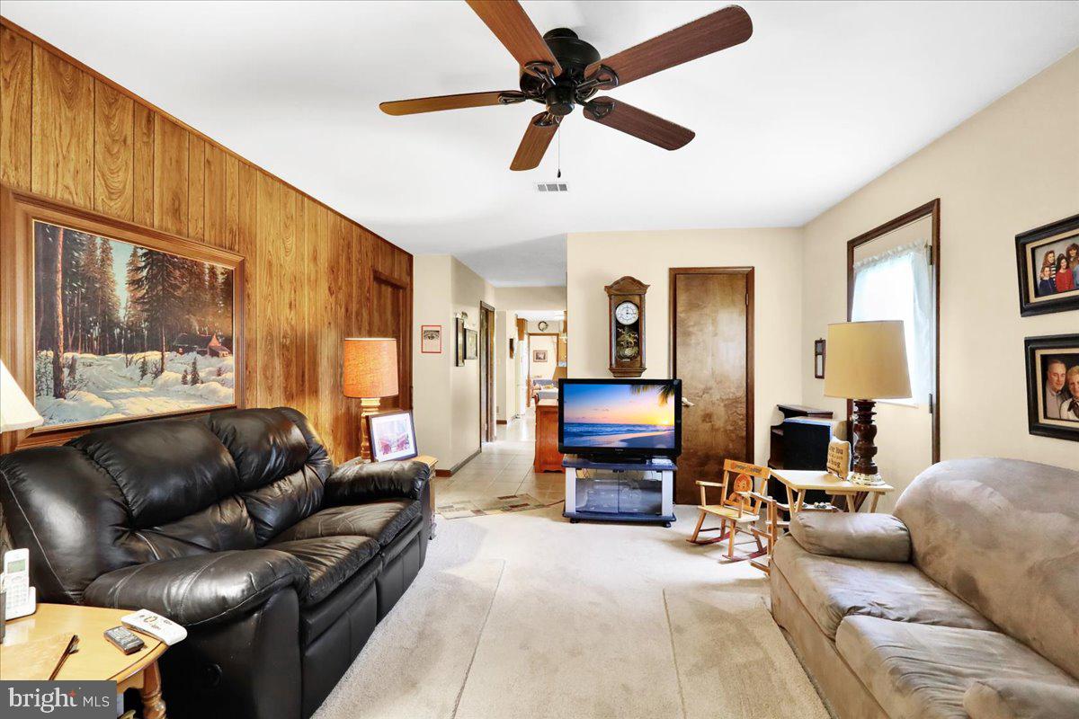 830 North Church Road Reading, PA 19608 - Photo 25 of 57 a living room with furniture a ceiling fan and a flat screen tv
