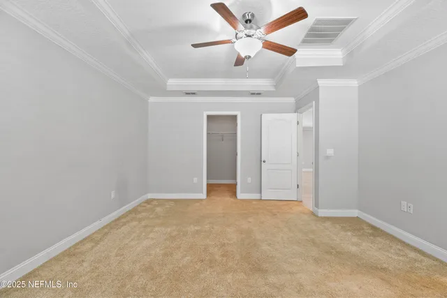 an empty room with a ceiling fan and a window