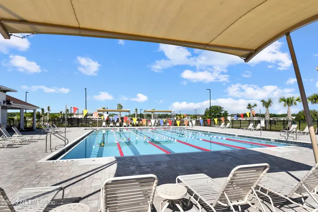 a view of a swimming pool and an outdoor seating