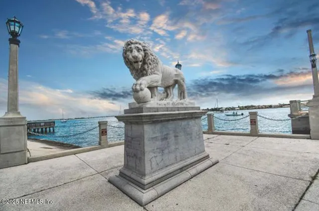 a view of a house with a yard balcony and tree