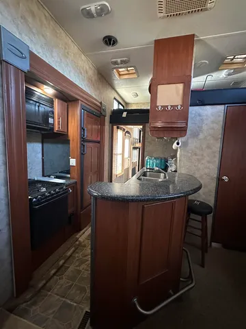 a kitchen with stainless steel appliances granite countertop a stove and a refrigerator