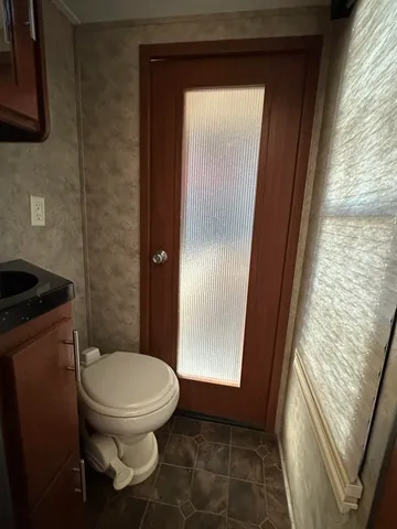 a bathroom with a toilet and a shower