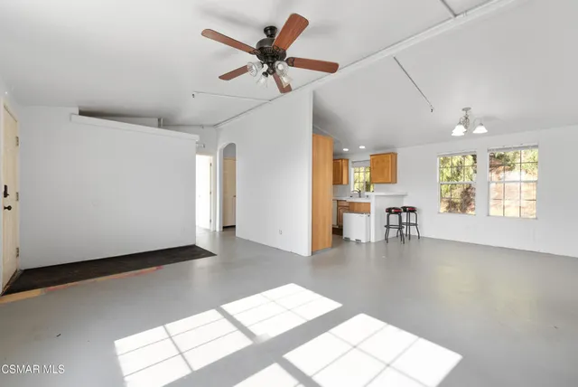 a view of a livingroom with a lounge chair and a large window