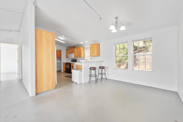 a view of kitchen with furniture and large window