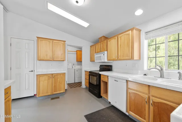 a kitchen with a sink cabinets and window