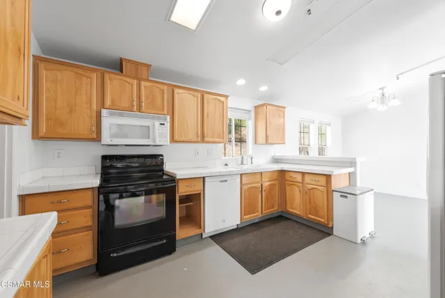 a kitchen with a sink stove and microwave
