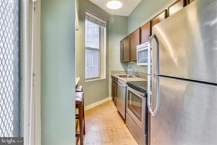 1900 3rd Street Northwest, Unit 1 Washington, DC 20001 - Photo 11 of 20 a kitchen with a refrigerator and a stove