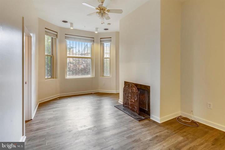 1900 3rd Street Northwest, Unit 1 Washington, DC 20001 - Photo 17 of 20 an empty room with wooden floor and windows