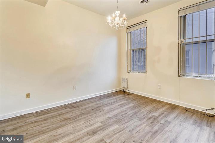1900 3rd Street Northwest, Unit 1 Washington, DC 20001 - Photo 4 of 20 a view of an empty room with wooden floor and a window