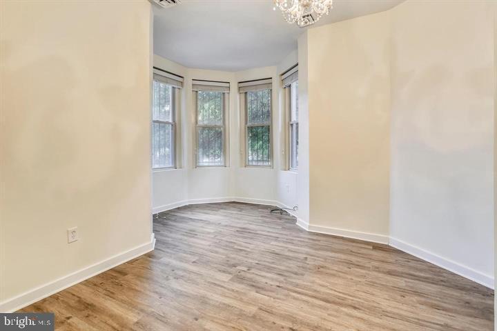 1900 3rd Street Northwest, Unit 1 Washington, DC 20001 - Photo 9 of 20 an empty room with wooden floor and windows