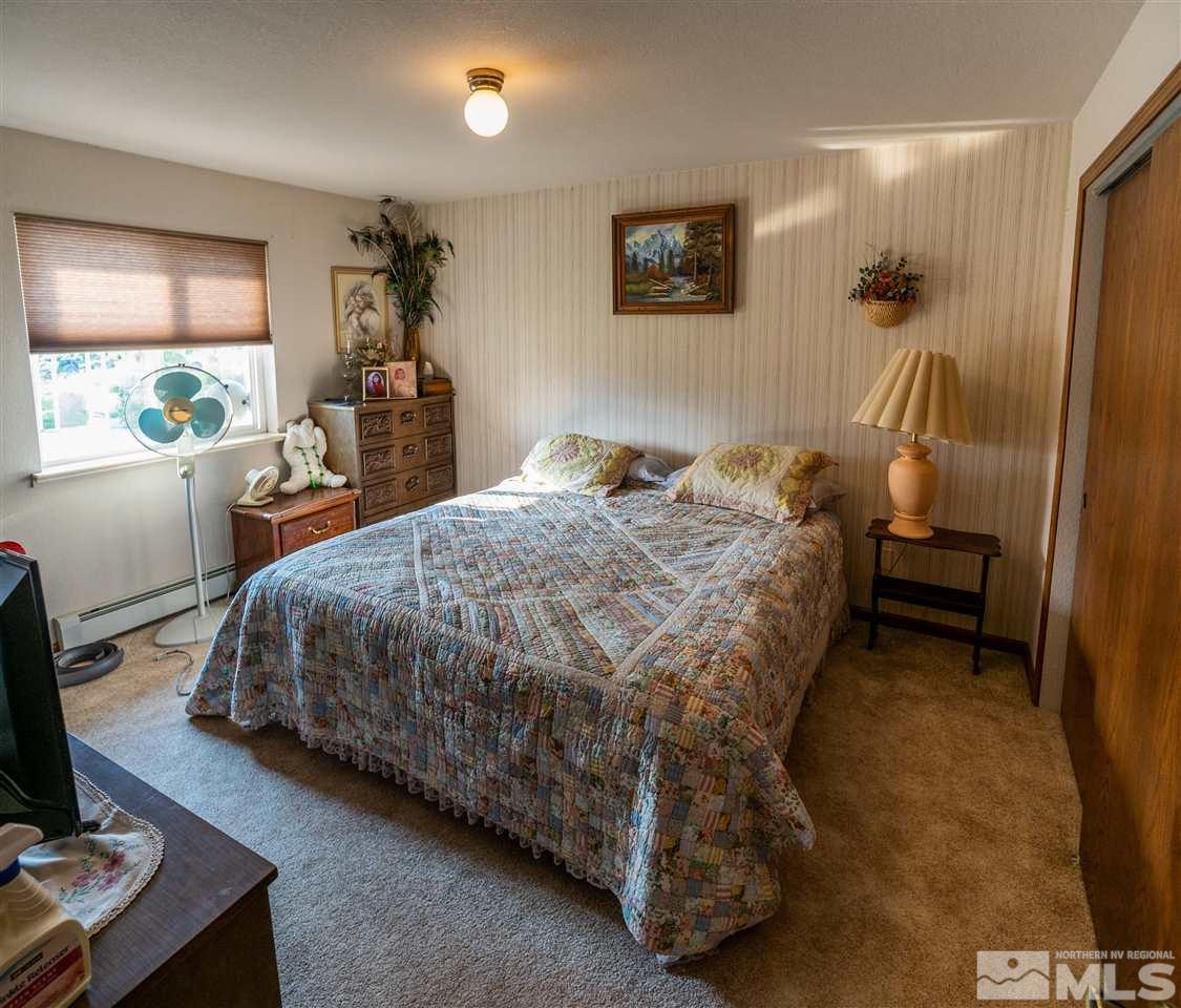 817 Rubio Way Gardnerville, NV 89460 - Photo 19 of 28 a bed sitting in a bedroom next to a window