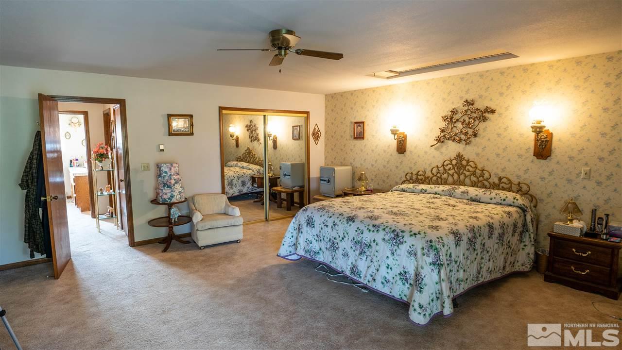 817 Rubio Way Gardnerville, NV 89460 - Photo 23 of 28 a bedroom with a bed and a chandelier