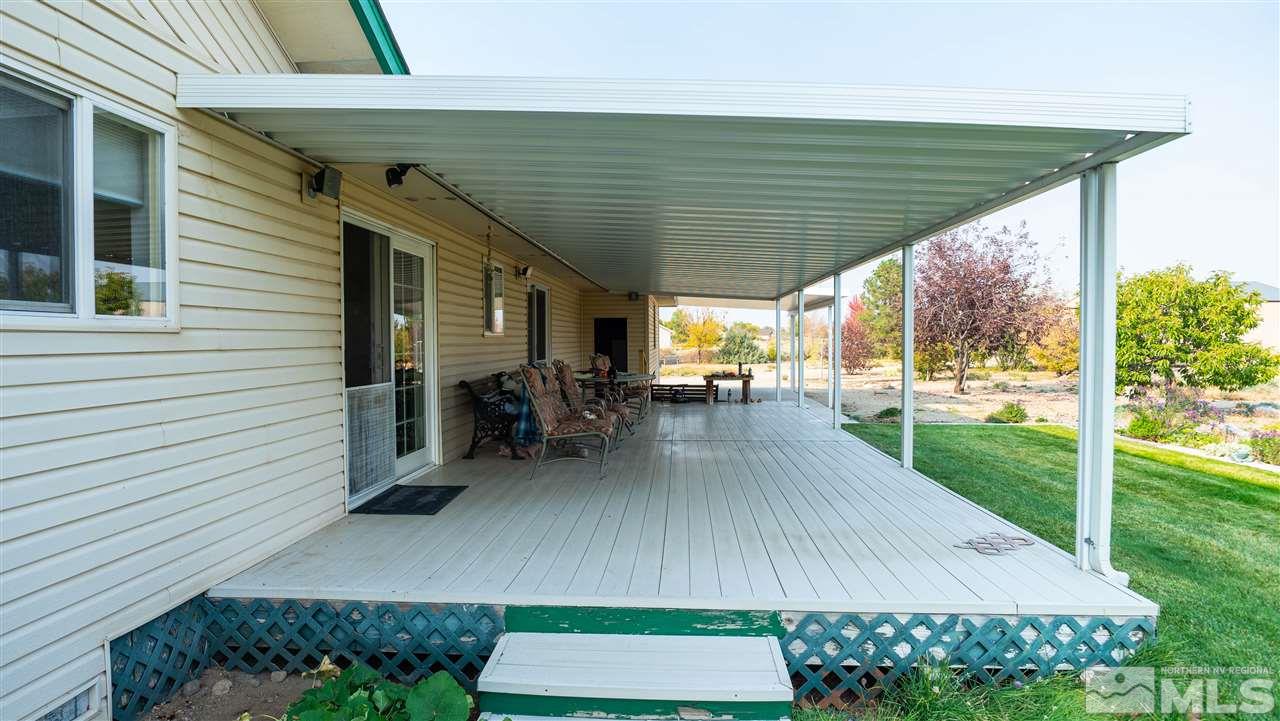 817 Rubio Way Gardnerville, NV 89460 - Photo 7 of 28 a view of a patio with table and chairs a barbeque with wooden fence