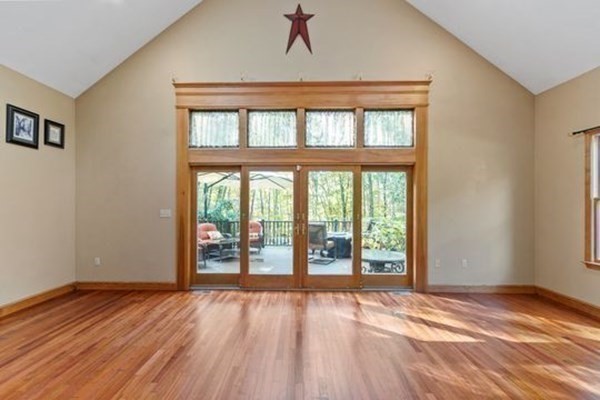 77 Teele Road Bolton, MA 01740 - Photo 14 of 41 a view of an empty room with wooden floor and a window