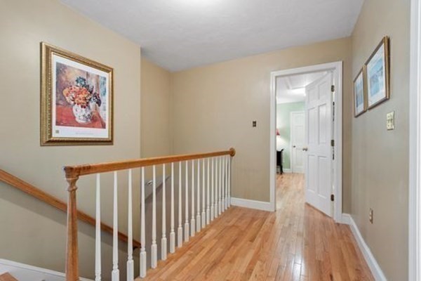 77 Teele Road Bolton, MA 01740 - Photo 18 of 41 a view of a hallway with wooden floor and a bathroom