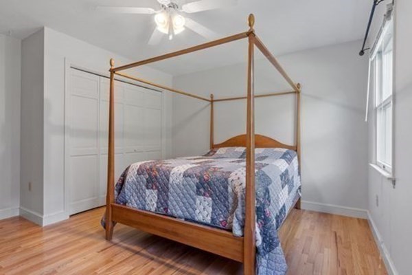 77 Teele Road Bolton, MA 01740 - Photo 22 of 41 a bedroom with a bed and a chandelier