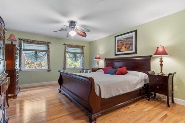 77 Teele Road Bolton, MA 01740 - Photo 24 of 41 a bedroom with a bed and a chandelier