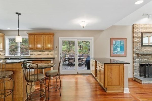 77 Teele Road Bolton, MA 01740 - Photo 9 of 41 a dining room with stainless steel appliances granite countertop a stove and a wooden floors