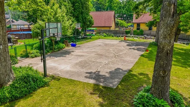 a view of a park with iron fence
