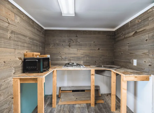 a view of a kitchen with a sink and microwave