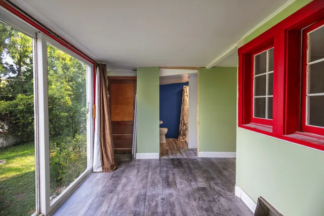 a view of a room with wooden floor and windows