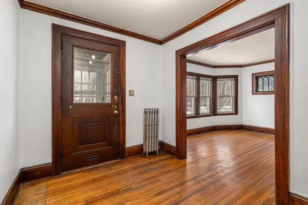 a view of room with window and wooden floor