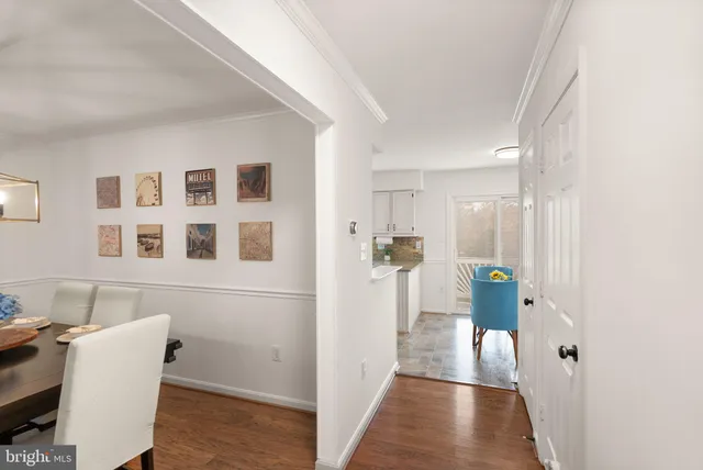 a kitchen with stainless steel appliances granite countertop a stove a refrigerator a sink a stove and white cabinets