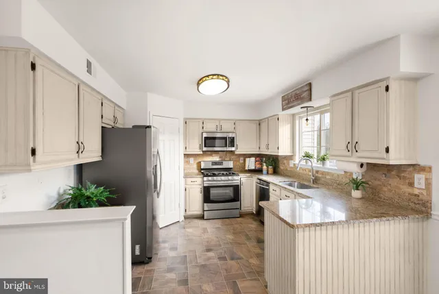 a room with furniture a flat screen tv and a window