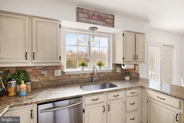 a view of a dining room with furniture a chandelier and wooden floor