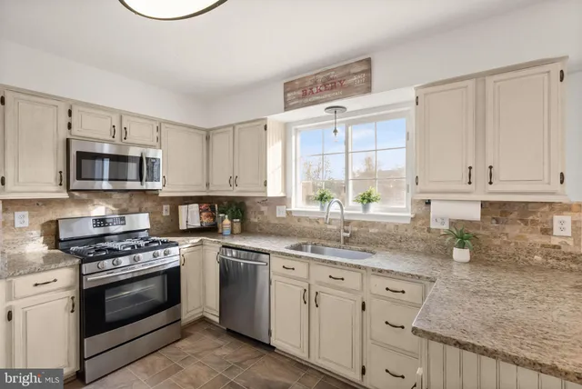 a view of a kitchen area with furniture and wooden floor