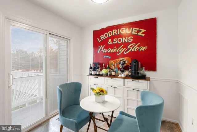 a living room with stainless steel appliances furniture and a view of kitchen