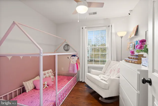 a living room with furniture and a ceiling fan