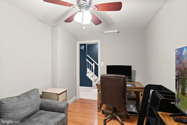 a view of a house with a small deck and a chair