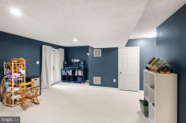 a front view of a building with a garden and plants