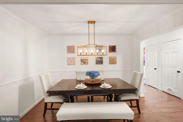 a view of a room with wooden floor and furniture