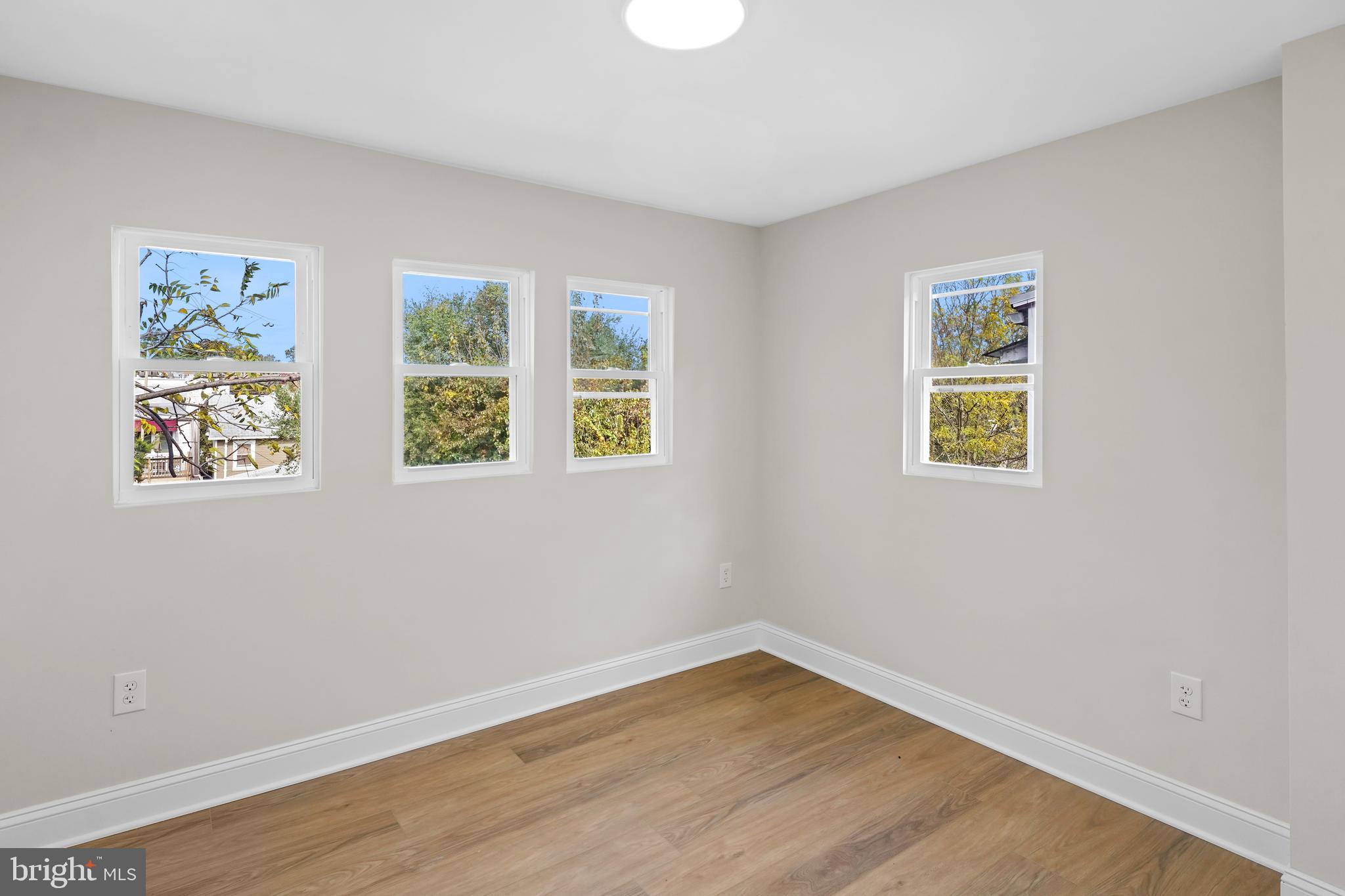 715 Longfellow Street Northwest Washington, DC 20011 - Photo 6 of 21 a view of an empty room with wooden floor and a window