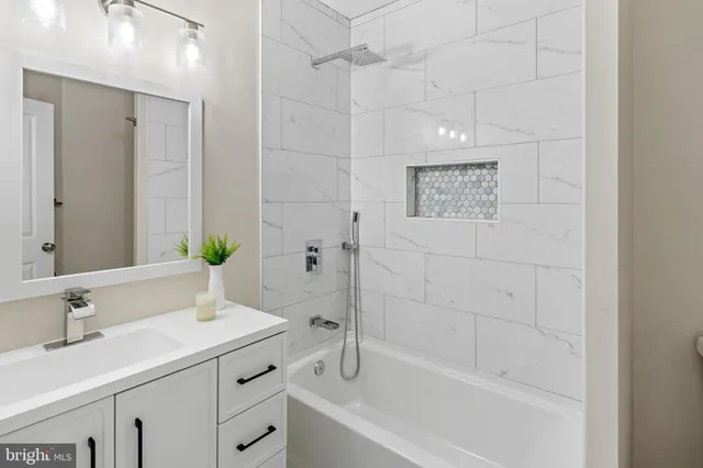 a bathroom with a bathtub sink vanity and mirror