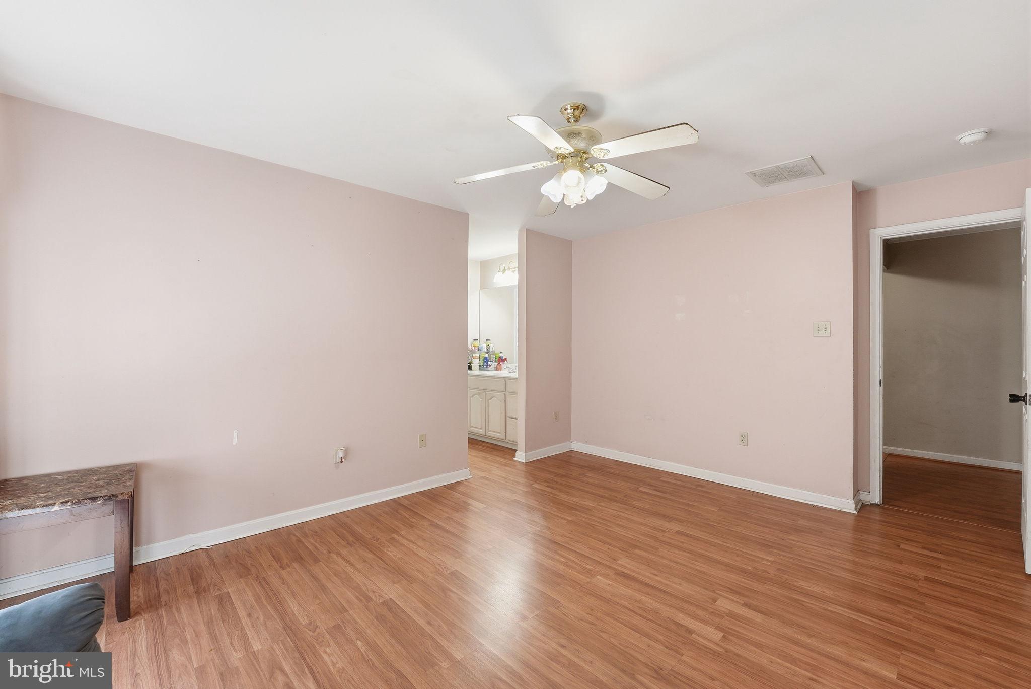 6870 Hawkins Gate Road La Plata, MD 20646 - Photo 15 of 24 an empty room with wooden floor and fan